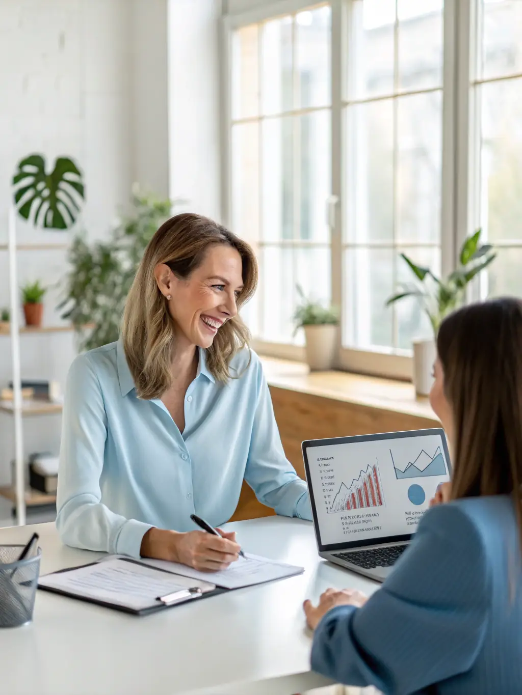 A modern office setting where AGCLA staff are assisting a local entrepreneur with accounting software and digital financial tools.